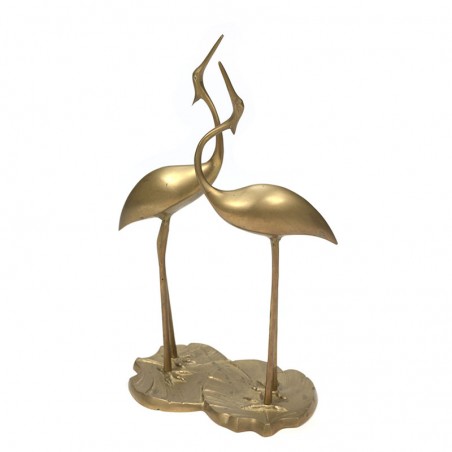 Two vintage brass birds on leaf