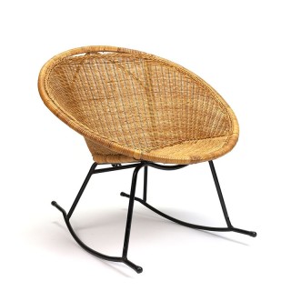 Wicker vintage rocking chair on metal base