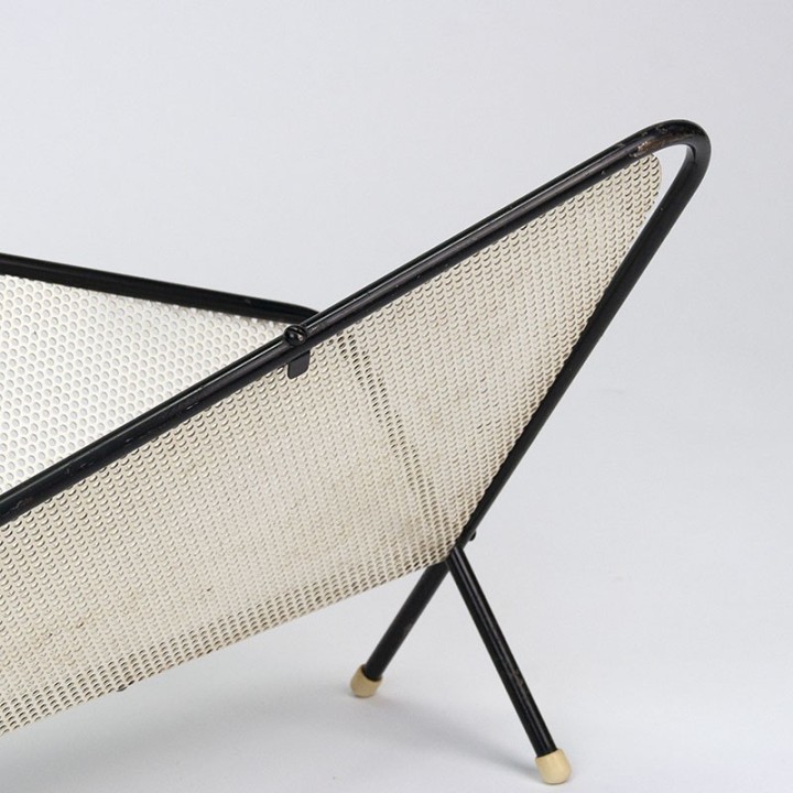 Symmetrical vintage perforated metal magazine rack