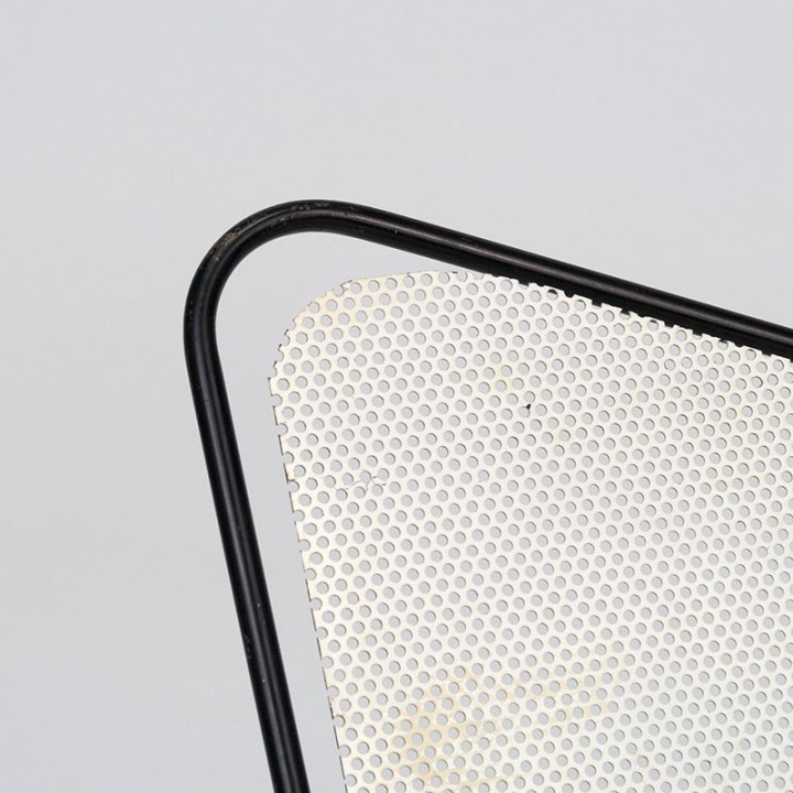 Symmetrical vintage perforated metal magazine rack