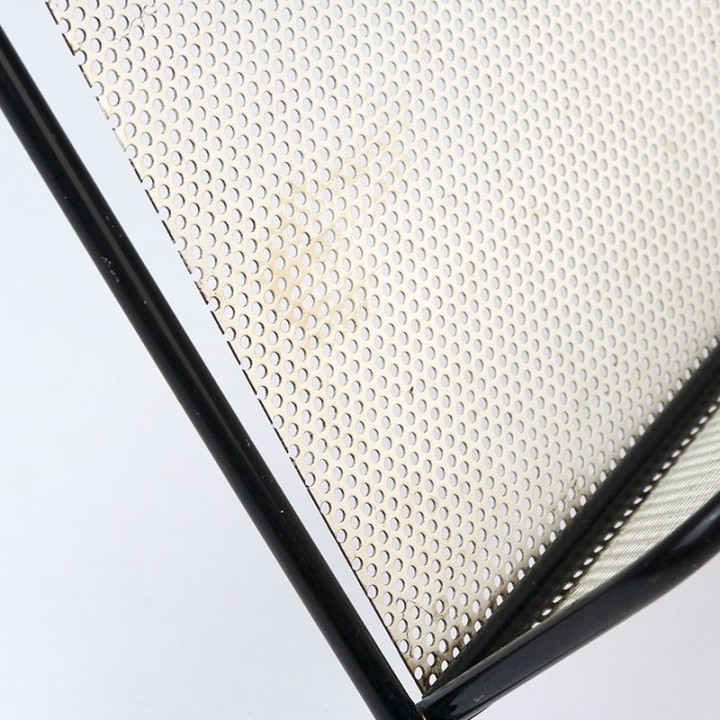 Symmetrical vintage perforated metal magazine rack