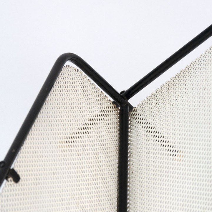 Symmetrical vintage perforated metal magazine rack