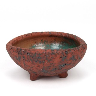 Vintage earthenware flower pot on a tripod