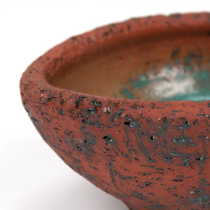 Vintage earthenware flower pot on a tripod