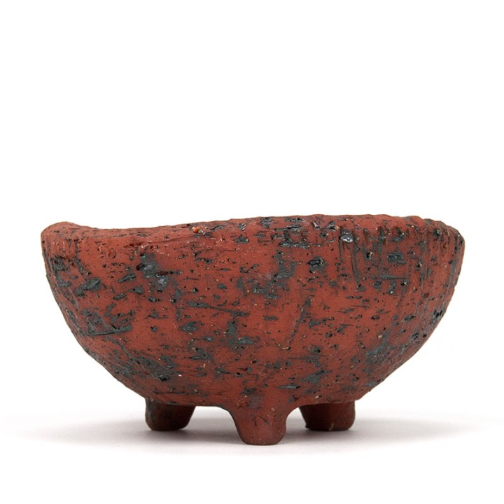 Vintage earthenware flower pot on a tripod