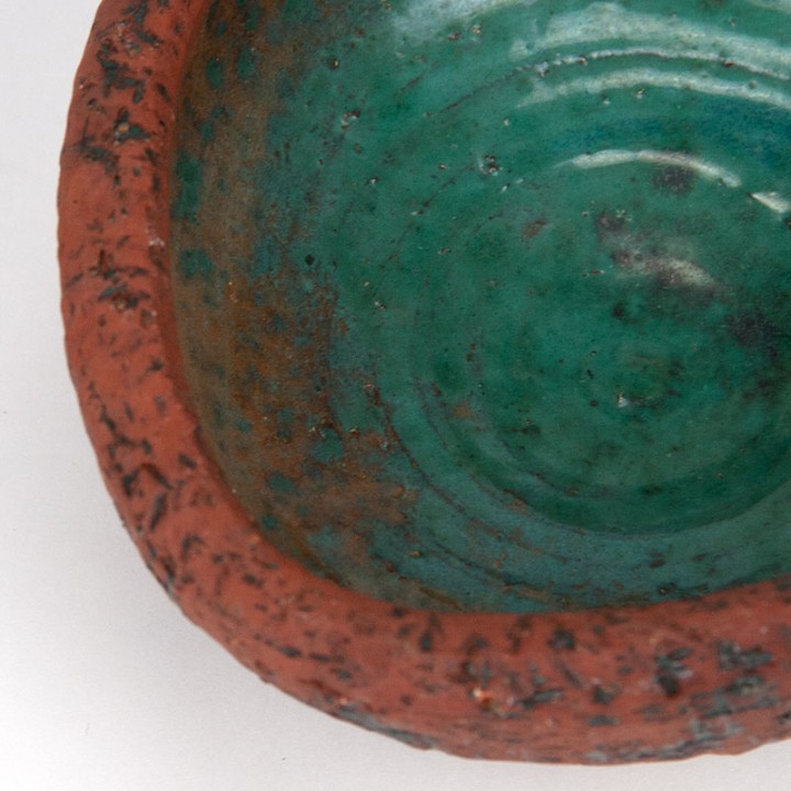 Vintage earthenware flower pot on a tripod